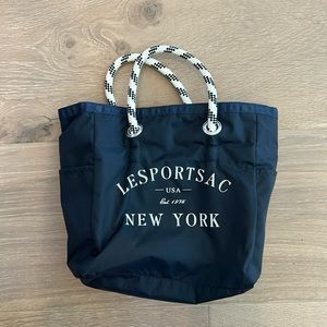 Reversible Le Sport tote bag: black on one side blue and white stripe on other